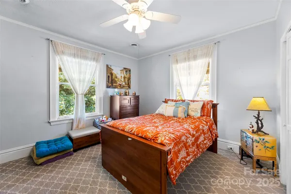 a bedroom with a bed and a chandelier