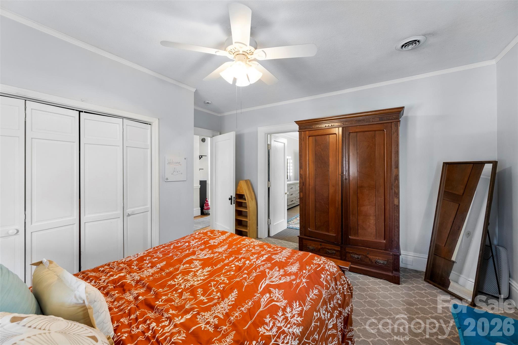 705 West Main Street Albemarle, NC 28001 - Photo 25 of 39 a bedroom with a large bed and a chandelier