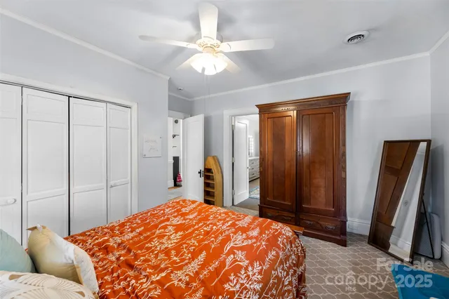 a bedroom with a large bed and a chandelier