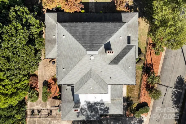 an aerial view of a house with a yard