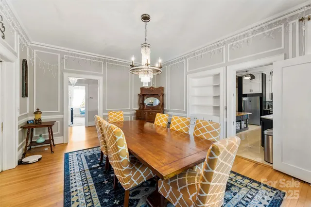 a living room with dining table and wooden floor