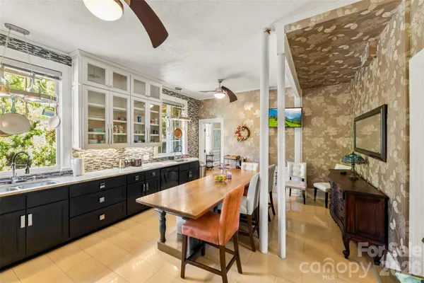 a dining room with a wooden table and chairs