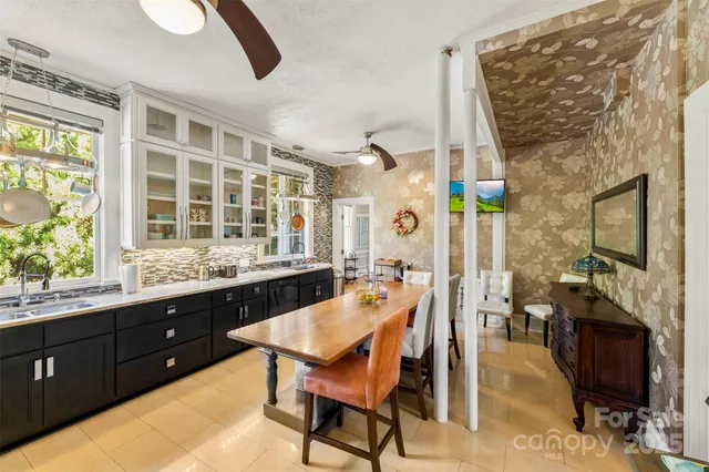 a dining room with a wooden table and chairs