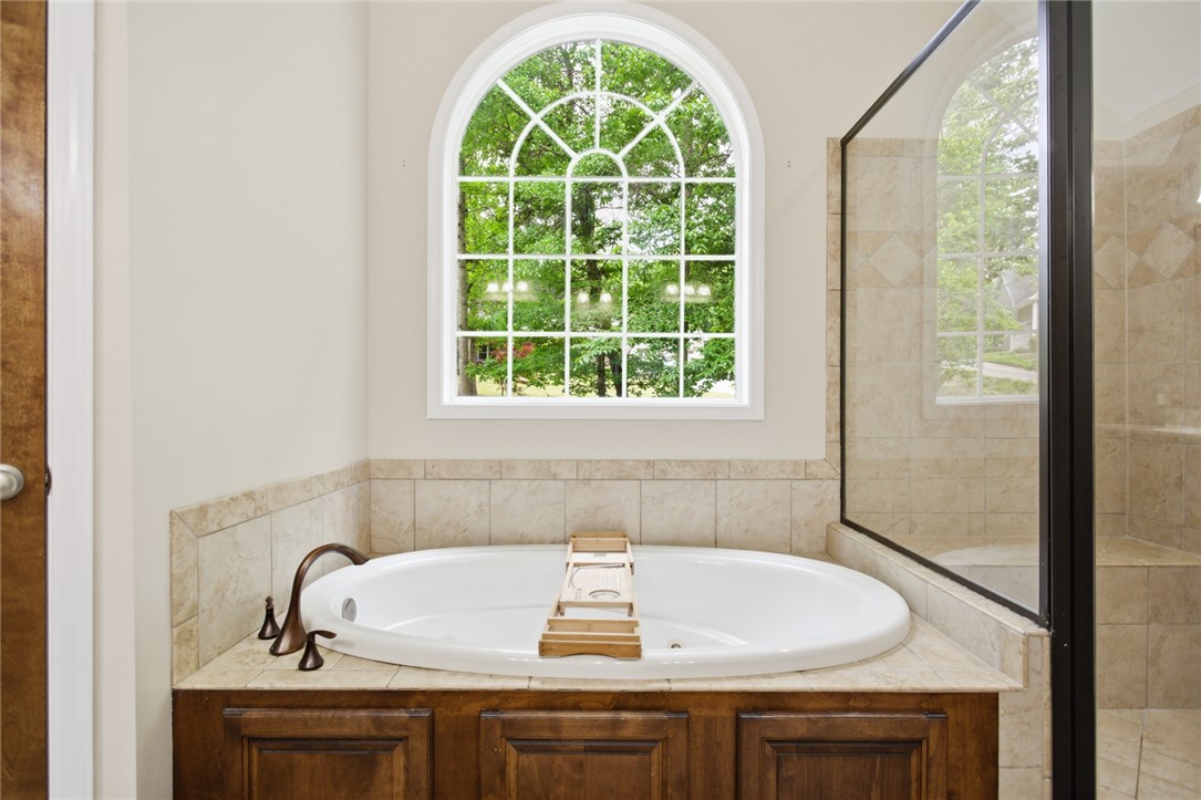 207 Devonhurst Drive Seneca, SC 29678 - Photo 21 of 50 An inviting soaking tub awaits beneath an arched window.