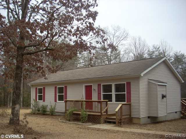 a front view of a house with yard and seating area