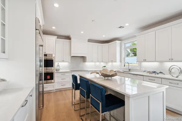 a kitchen with a sink a stove a counter space and cabinets