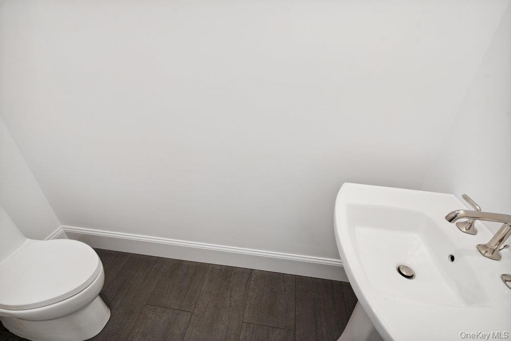 46 Plainview Road Woodbury, NY 11797 - Photo 19 of 46 a bathroom with a toilet and sink