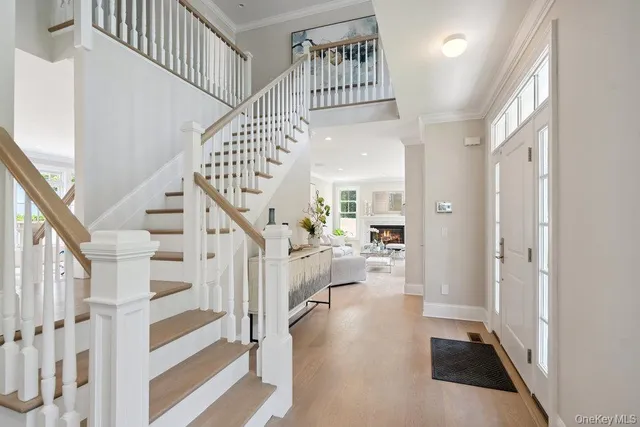 a view of entryway and hall with wooden floor