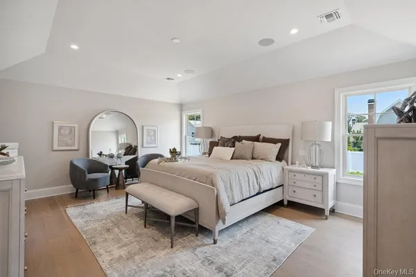 a bedroom with a bed large window and a couch