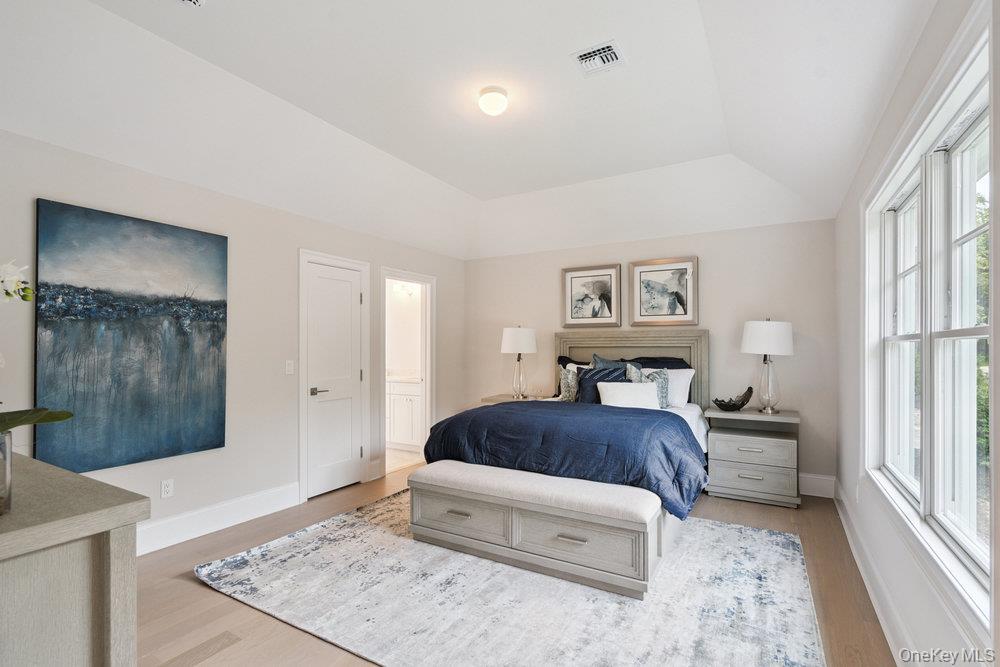 46 Plainview Road Woodbury, NY 11797 - Photo 32 of 46 a spacious bedroom with a bed and a large window