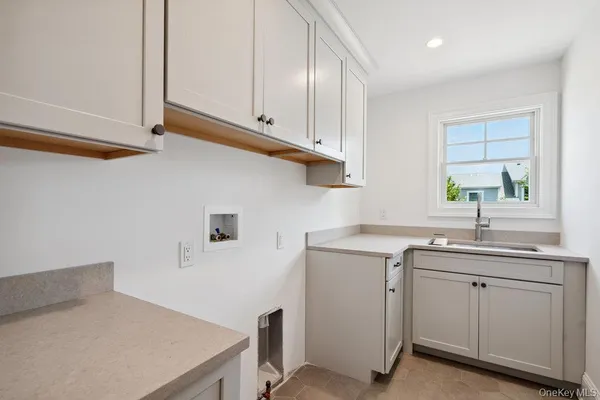 a kitchen with cabinets appliances a sink and a window