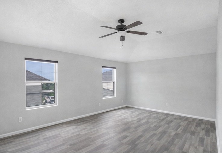 1726 Sun Point Court Humble, TX 77396 - Photo 12 of 26 a view of empty room with wooden floor and fan