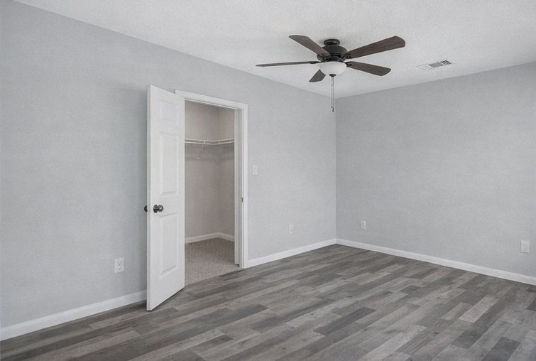 1726 Sun Point Court Humble, TX 77396 - Photo 13 of 26 an empty room with wooden floor and ceiling fan