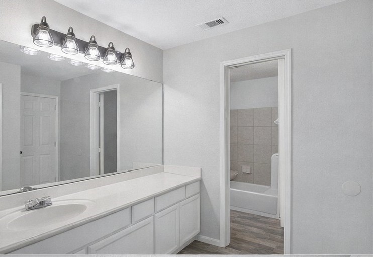 1726 Sun Point Court Humble, TX 77396 - Photo 16 of 26 a bathroom with a granite countertop sink a toilet and shower