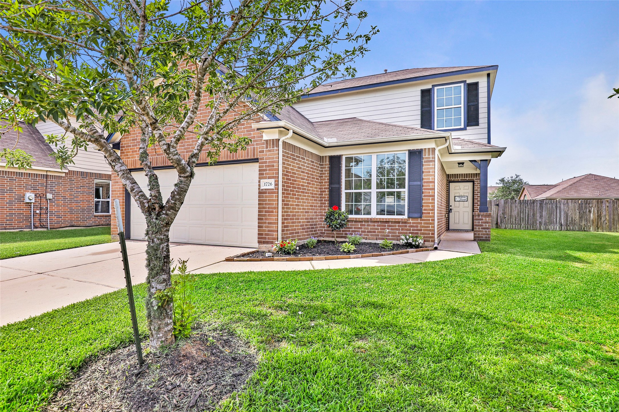 1726 Sun Point Court Humble, TX 77396 - Photo 2 of 26 a front view of a house with yard and green space