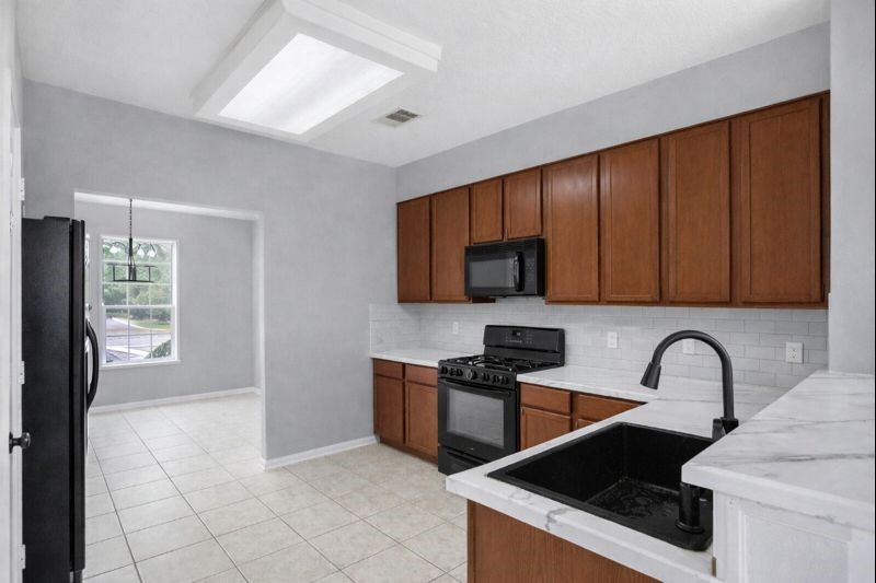 1726 Sun Point Court Humble, TX 77396 - Photo 4 of 26 a kitchen with stainless steel appliances granite countertop a stove a sink and a microwave