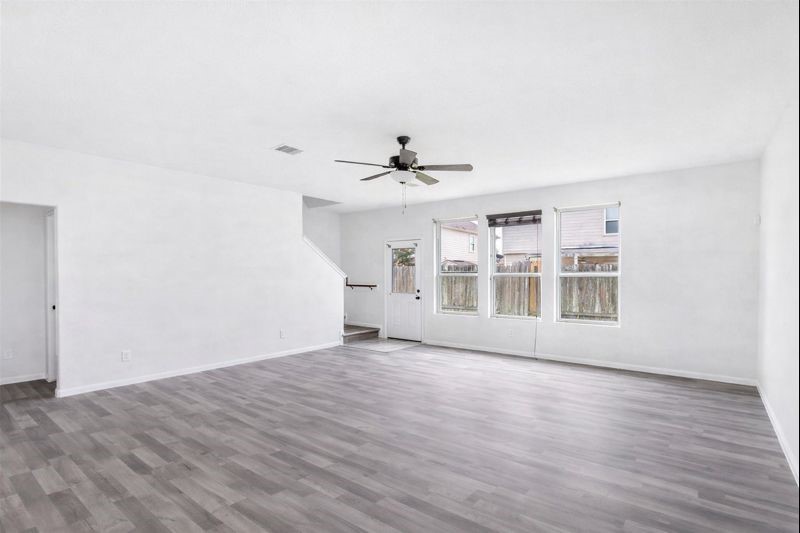 1726 Sun Point Court Humble, TX 77396 - Photo 5 of 26 a view of an empty room with a window and wooden floor