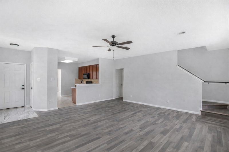 1726 Sun Point Court Humble, TX 77396 - Photo 6 of 26 wooden floor in an empty room with a window