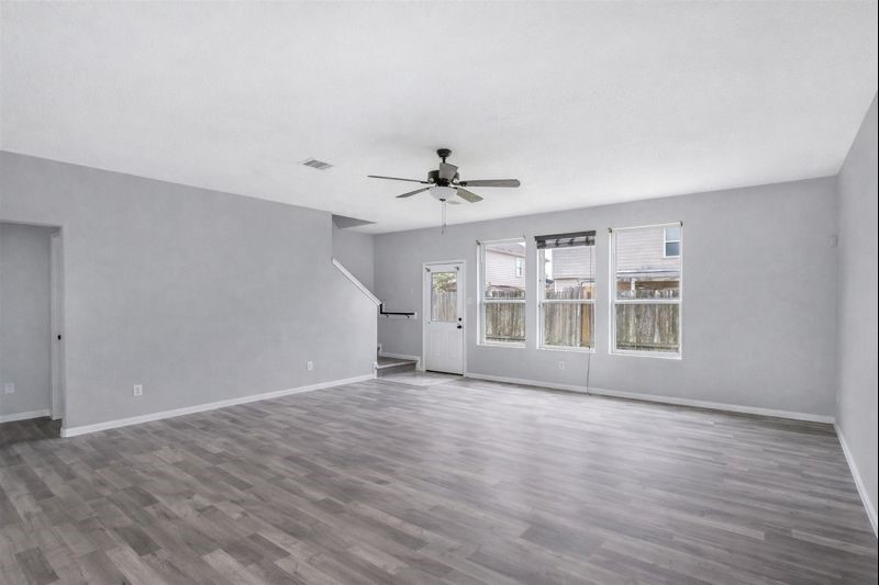 1726 Sun Point Court Humble, TX 77396 - Photo 8 of 26 a view of an empty room with wooden floor and a window