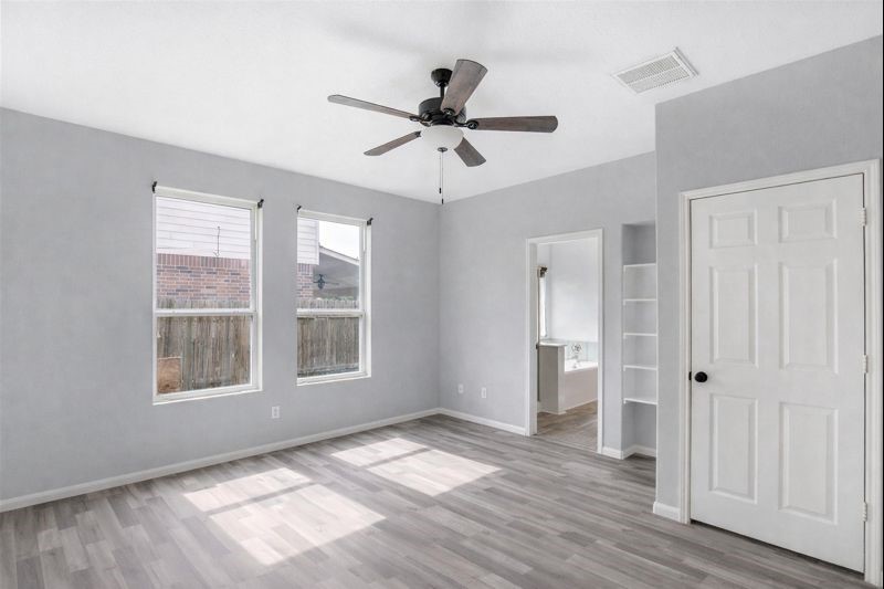 1726 Sun Point Court Humble, TX 77396 - Photo 9 of 26 a view of an empty room with a window and wooden floor