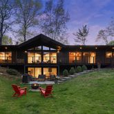 a backyard of a house with table and chairs