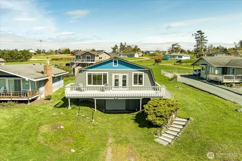 a front view of a house with a big yard