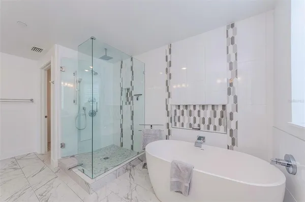 a bathroom with a bathtub and a shower
