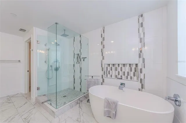 a bathroom with a bathtub and a shower