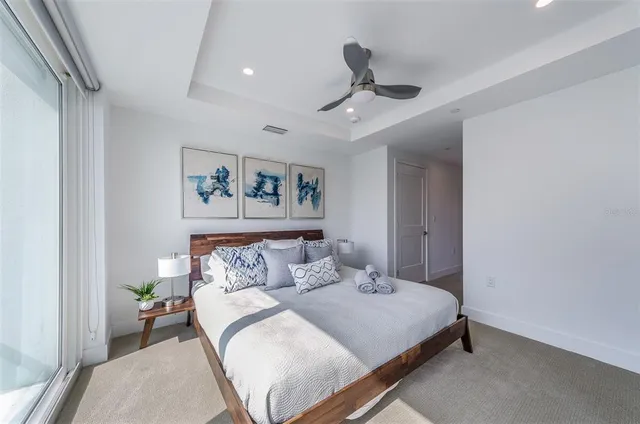 a bedroom with a large bed and a chandelier