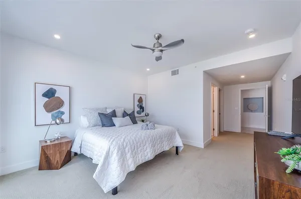 a bed room with a bed and a painting