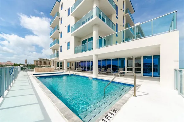 a view of a house with swimming pool and sitting area
