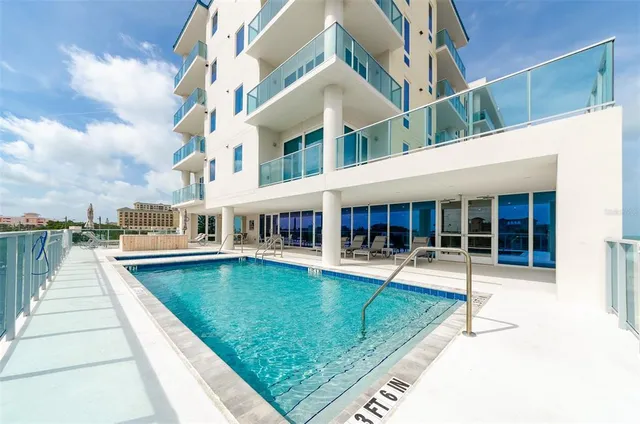 a view of a house with swimming pool and sitting area