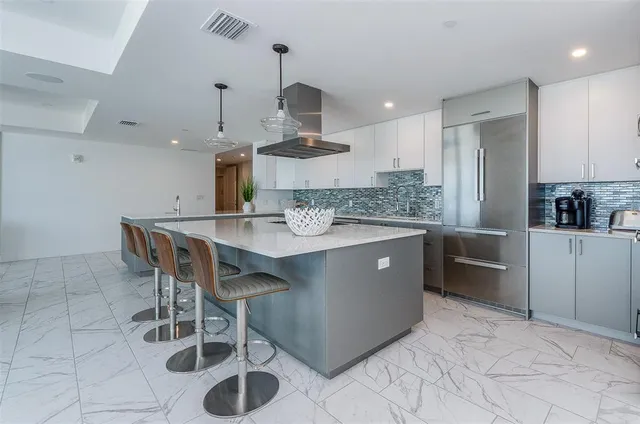 a kitchen with a sink a counter space appliances and cabinets