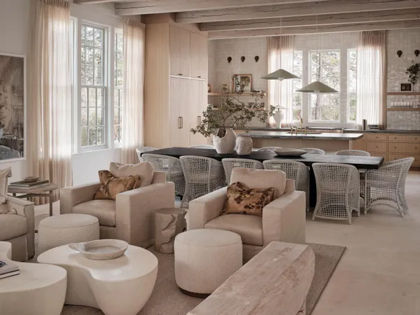 a living room with furniture and large windows