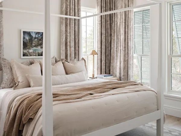 a bed sitting in a bedroom next to a window
