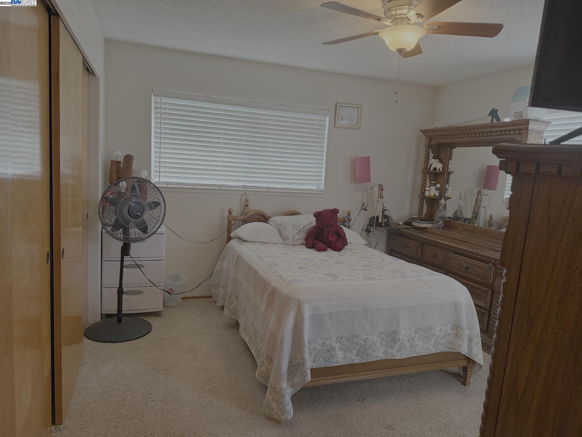 701 North 3rd Street Patterson, CA 95363 - Photo 11 of 23 a bedroom with a bed and a chandelier