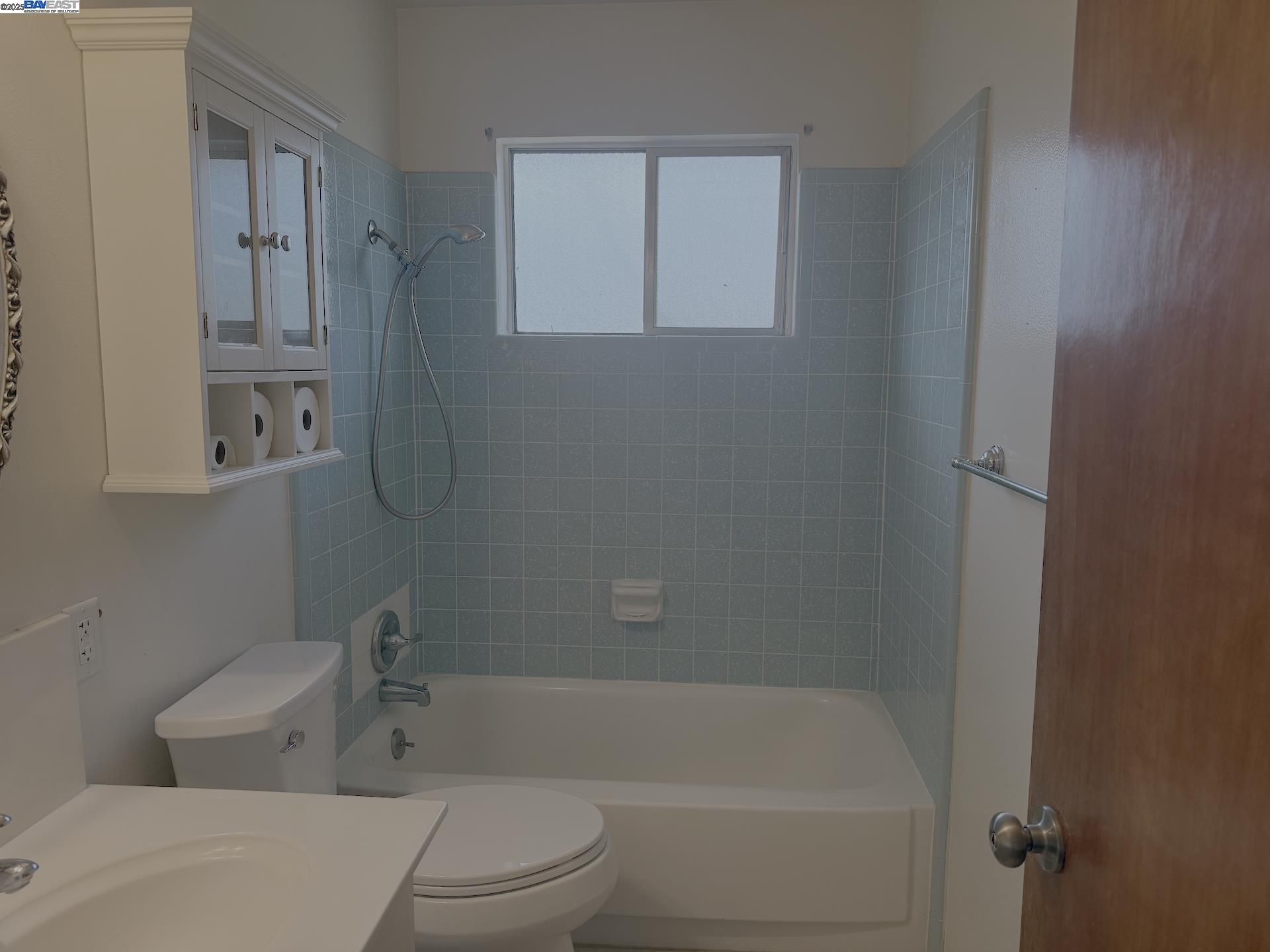 701 North 3rd Street Patterson, CA 95363 - Photo 13 of 23 a white bath tub sitting next to a white toilet