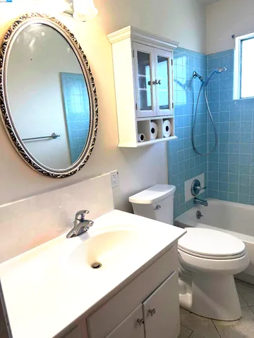 a bathroom with a sink mirror and toilet