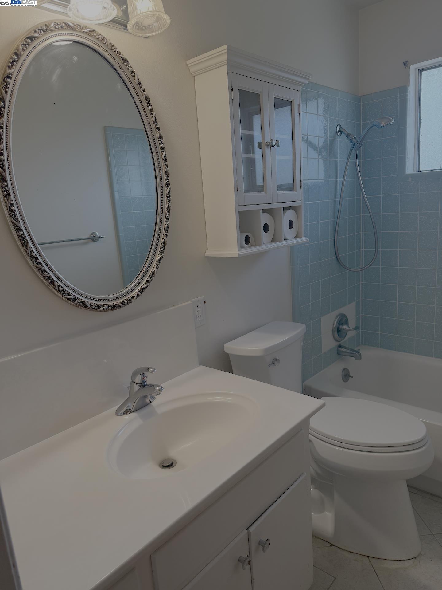 701 North 3rd Street Patterson, CA 95363 - Photo 14 of 23 a bathroom with a sink mirror and toilet