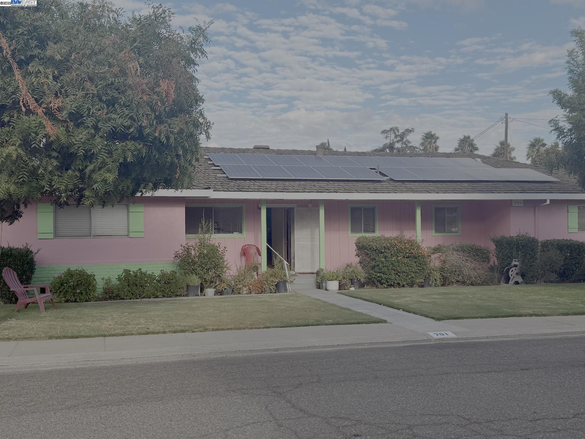 701 North 3rd Street Patterson, CA 95363 - Photo 2 of 23 a front view of a house with a yard and potted plants