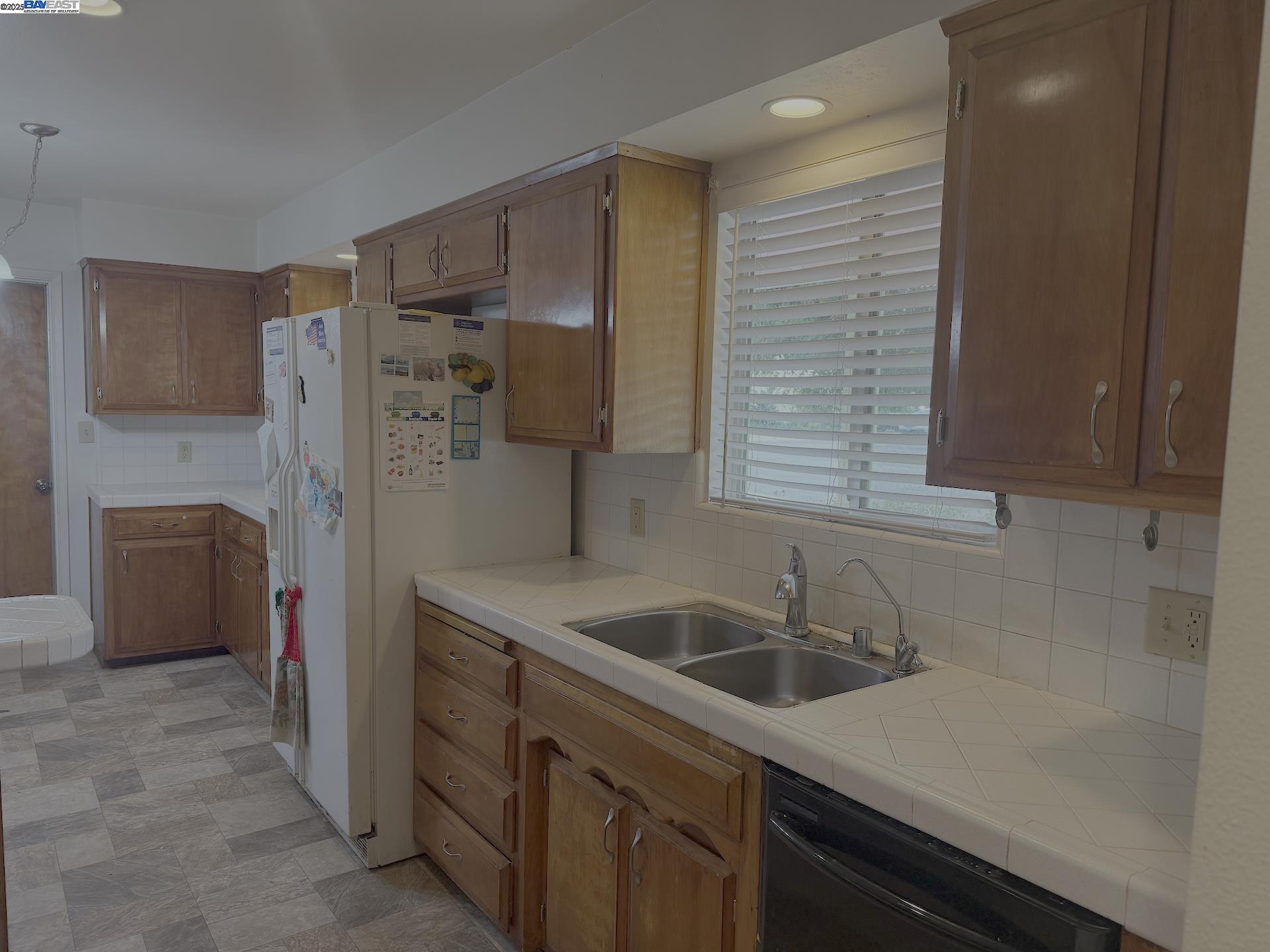701 North 3rd Street Patterson, CA 95363 - Photo 22 of 23 a kitchen that has a sink a stove and refrigerator