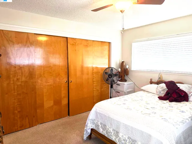 a bedroom with a bed and a large window