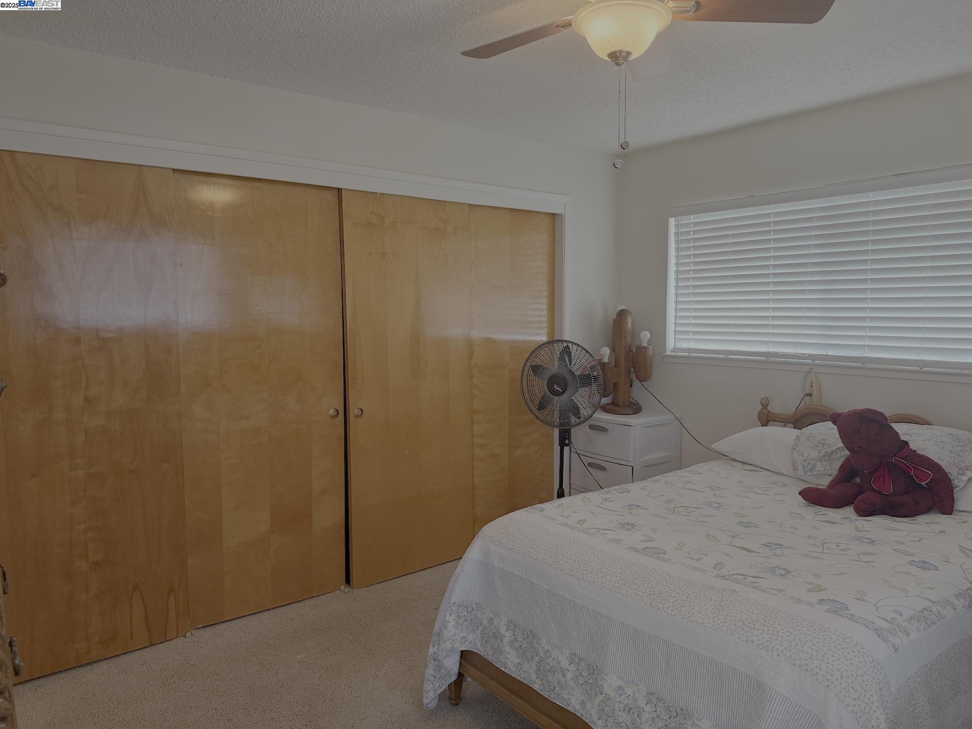 701 North 3rd Street Patterson, CA 95363 - Photo 10 of 23 a bedroom with a bed and a large window