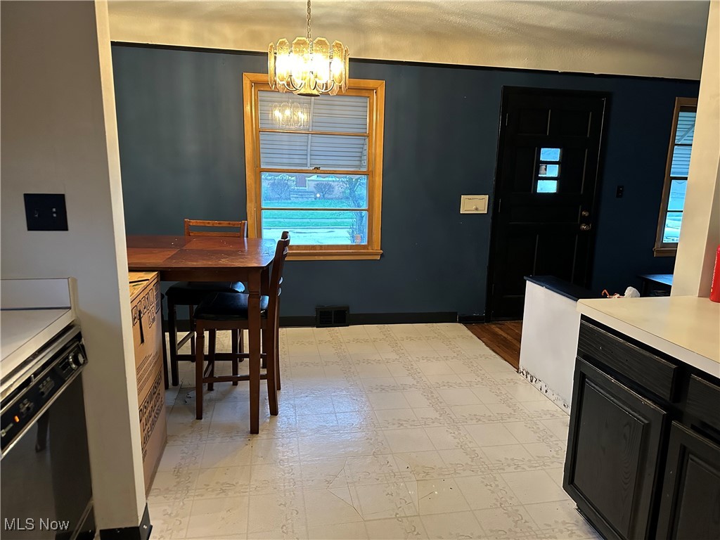 12303 Orme Road Garfield Heights, OH 44125 - Photo 3 of 22 Dining area with visible vents and an inviting chandelier