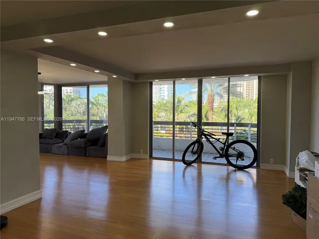 a view of a room with gym equipment and floor to ceiling window