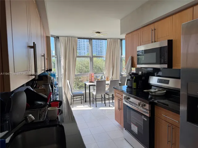 a kitchen with a sink refrigerator and microwave