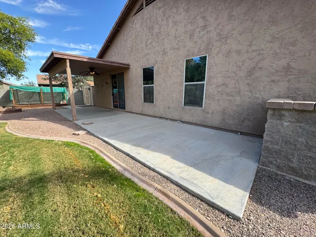 a view of a house with backyard and sitting area