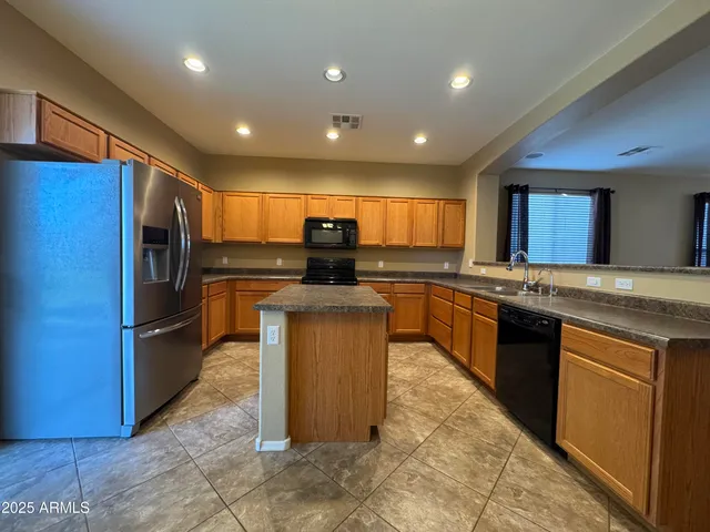 a kitchen with refrigerator cabinets and furniture