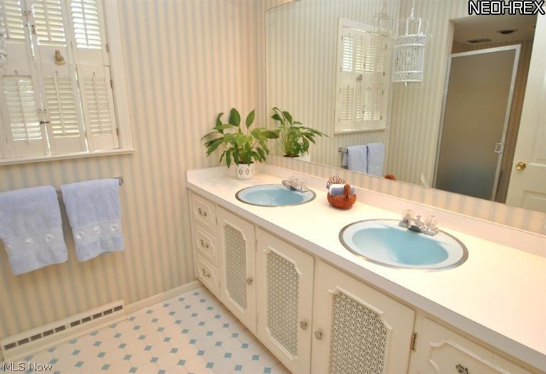 340 Tremont Road Akron, OH 44313 - Photo 21 of 25 Second floor main bath has a window, large vanity w/double sinks & mirror and ceramic tile floor.