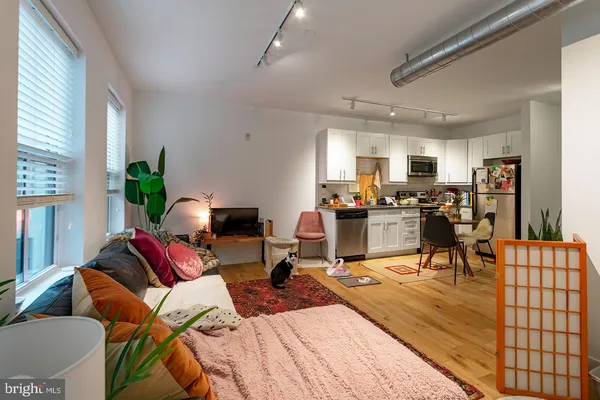 a room with gym equipment and wooden floor